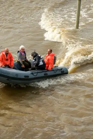 Pessoas num barco de resgate no meio das cheias em Alcácer do Sal.